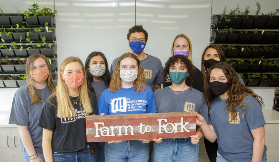 Students pose together with Farm to Fork sign