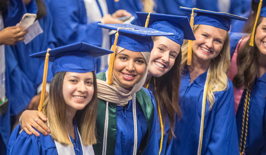 Students smiling together at graduation